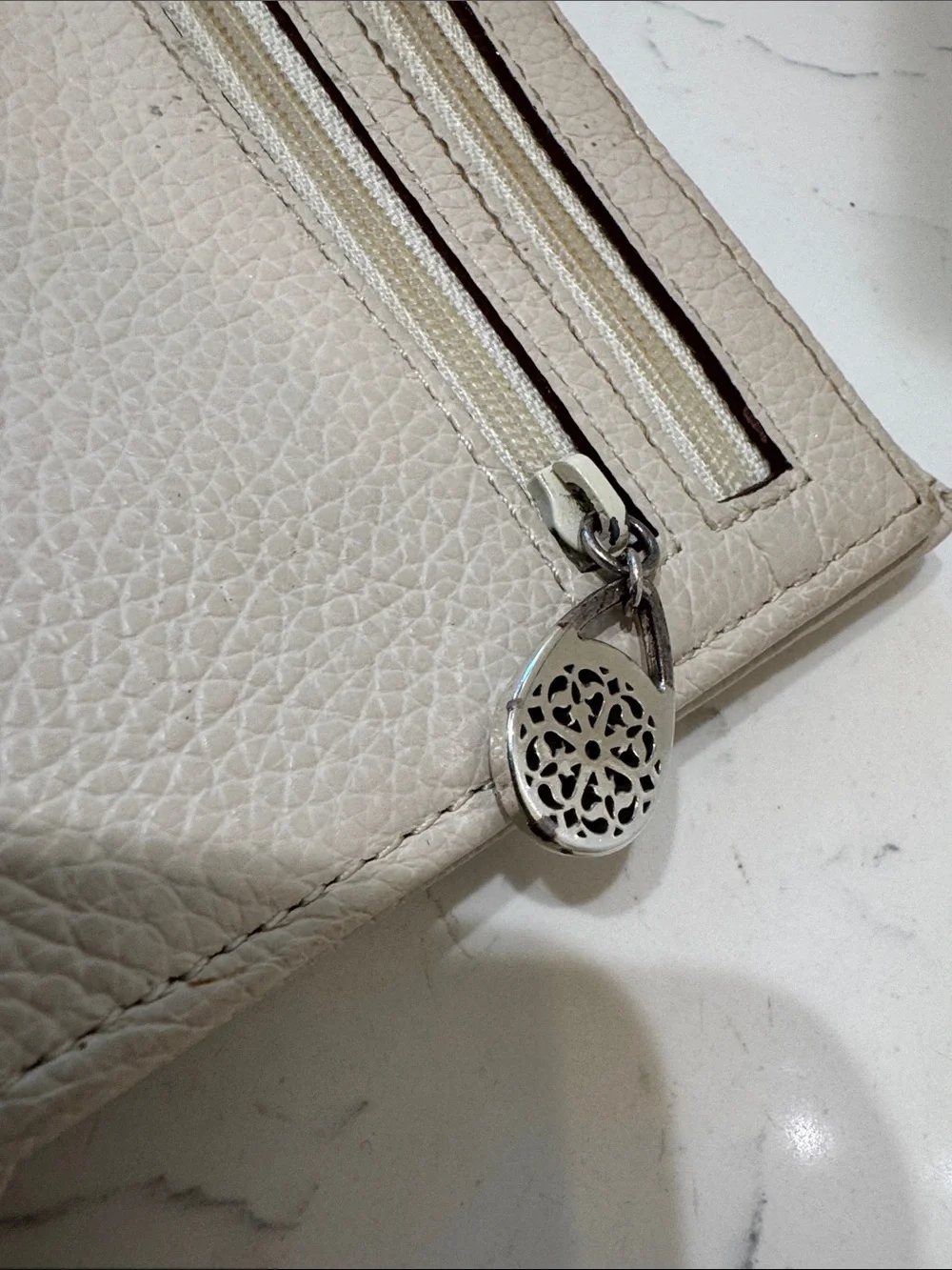 Brighton Cream Pebbled Leather Ferrara Fold Wallet with Embossed Medallion